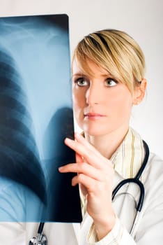 young women doctor looking at x-ray photo