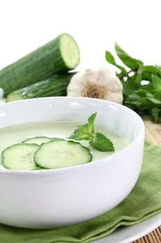 cold cucumber soup with cucumber slices and mint
