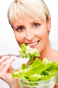 young attractive woman eating salad close up