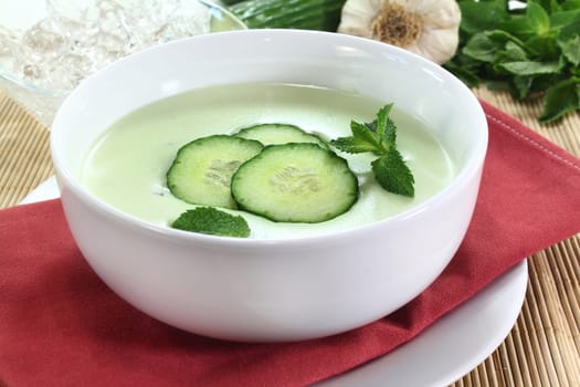 cold cucumber soup with cucumber slices and mint