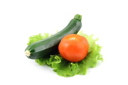 details of a fresh zucchini and tomato isolated on white on salad