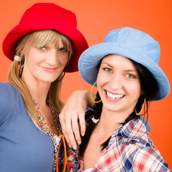 Two woman friends young wear funny hats smiling crazy outfit