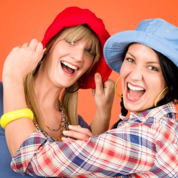 Two woman friends young wear funny hats smiling crazy outfit