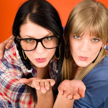 Two woman friends young send kiss smiling crazy outfit