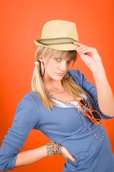 Young girl fashion outfit posing wear hat on orange background