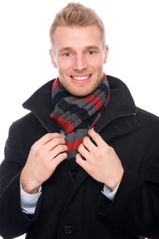 Studio shot of a young man with a scarf and a coat
