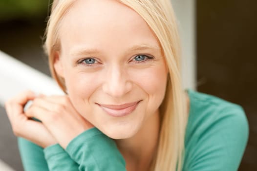 Portrait of a young and smiling woman in the park