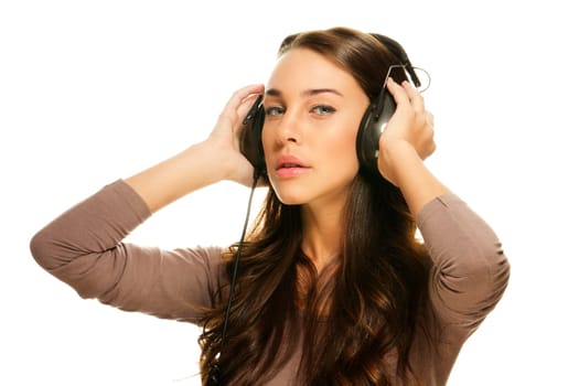 Young beautiful woman with headphones on white background