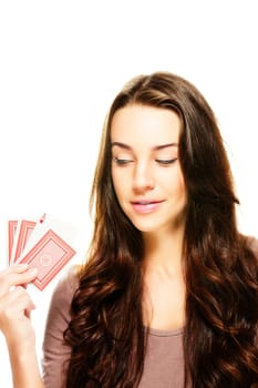 Young woman looking at her poker cards on white background