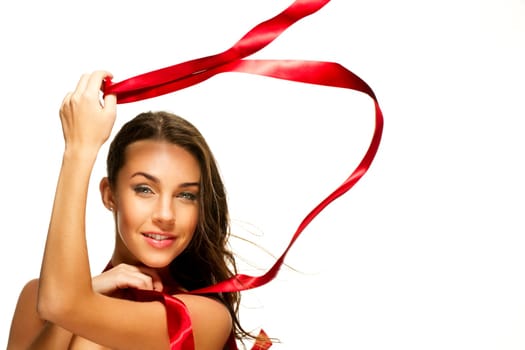 Happy woman playing with red ribbon on white background