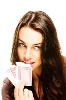Young woman choosing poker card with teeth on white background