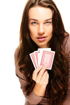 Young woman with poker cards on white background