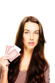 Young woman with poker cards on white background