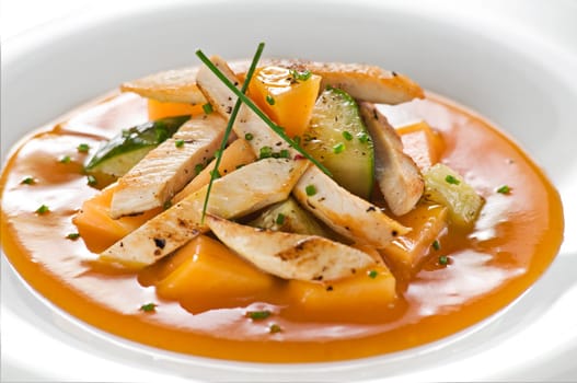 Roasted chicken in orange sauce with melone and cucumber