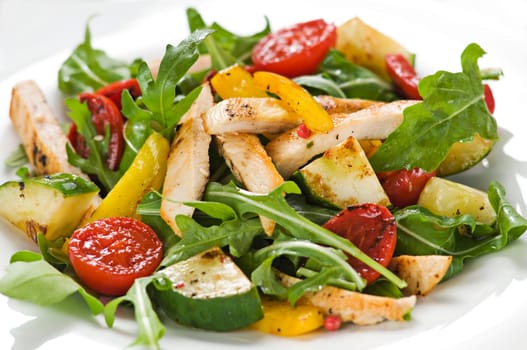 Chicken salad with rocket and vegetables close up