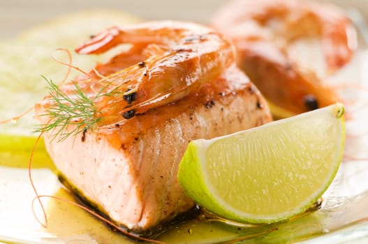 Grilled salmon and prawn with lime close up