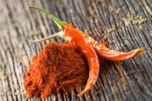 Two chilli pepers with powder close up shoot