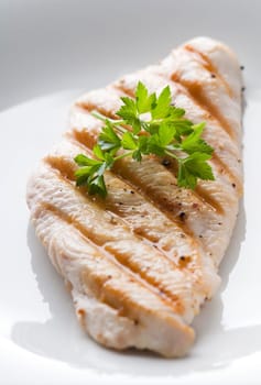 Fresh grilled chicken steak with parsley close up