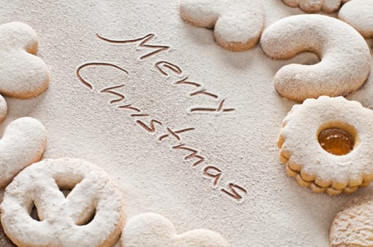 Merry christmas text with cookies close up shoot