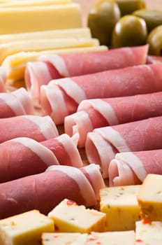 Fresh prosciutto with olives and cheese close up shoot