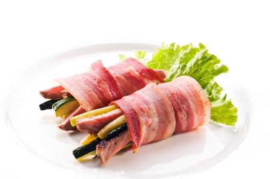 Roasted bacon rolls filled with beef and pumpkin close up