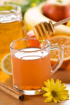 cup of hot tea with honey and cinnamon