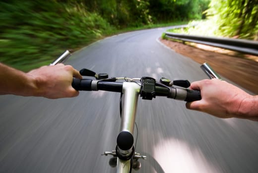 Mountain biking down hill descending fast close up