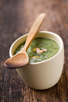 Fresh green pumpkin soup in a bowl close up