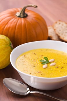 Fresh pumpkin soup with parsley close up