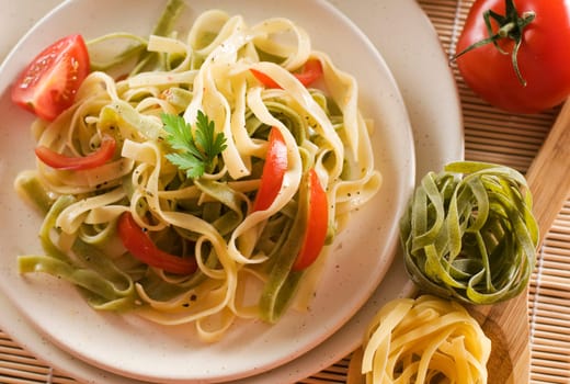 Mixed pasta with tomato and parsley close up shoot
