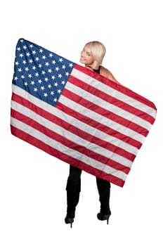 A beautiful young woman holding an American flag.