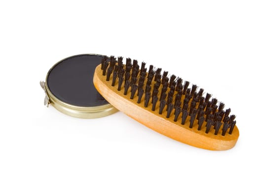 Black shoe polish with shoe brush set on white background