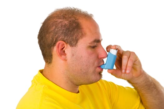 Young man with metered-dose inhaler - isolated on white background