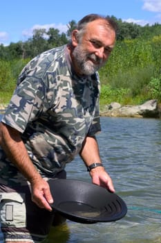 prospector panning for gold in rivers in France in the Gard region