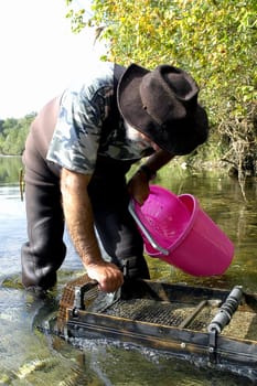 prospector panning for gold in rivers in France in the Gard region