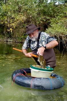 prospector panning for gold in rivers in France in the Gard region