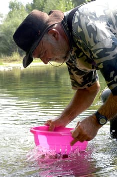 prospector panning for gold in rivers in France in the Gard region