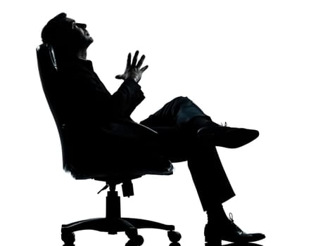 one caucasian business man relaxing thinking sitting in armchair silhouette Full length in studio isolated on white background