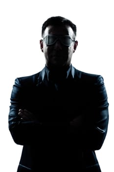 one caucasian man portrait silhouette serious arms crossed strange glasses in studio isolated white background