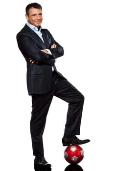 one caucasian business man standing arms crossed foot on soccer ball in studio isolated on white background