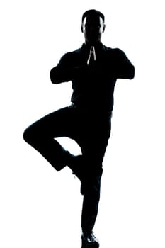 one caucasian business man yoga tree pose  full length silhouette in studio isolated white background