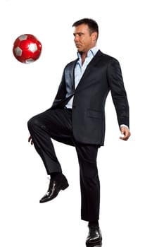 one caucasian business man playing juggling soccer ball in studio isolated on white background