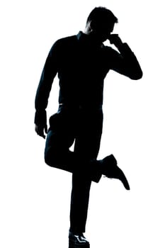 one caucasian man  looking at his shoes unpleasant smell full length silhouette in studio isolated white background