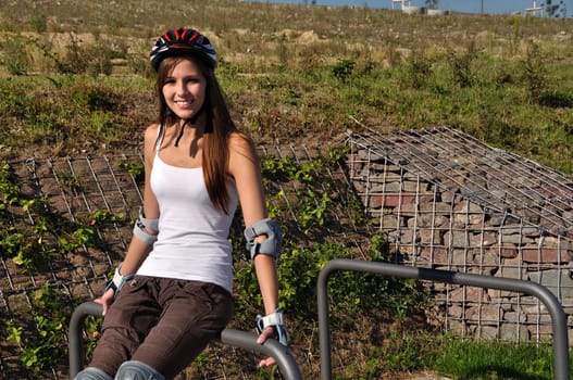 Young girl takes a break at the side of the road after sports