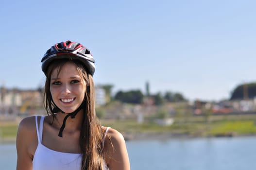 The sun is shining in summer and a woman is doing sports