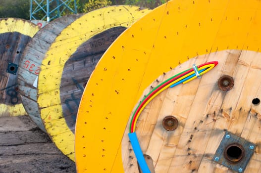 cable drums with several colored cables protected by a blue one.