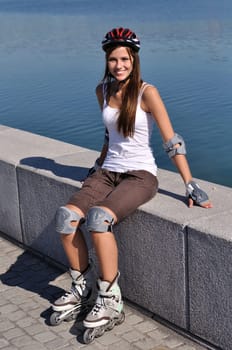 A skater wears her complete protective equipment on her body