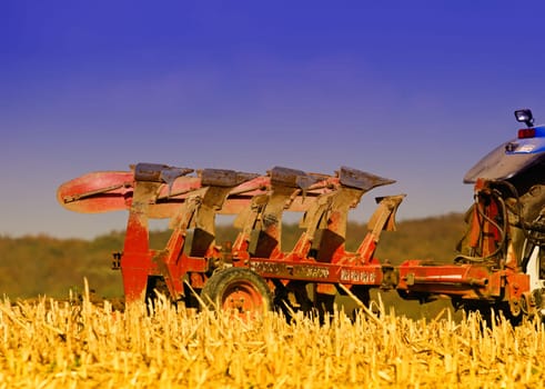 a farmer turns the land