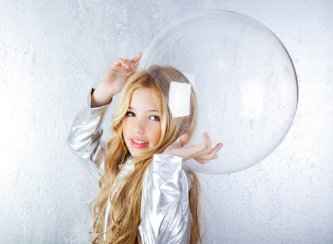 Astronaut futuristic kid girl with silver uniform and glass helmet
