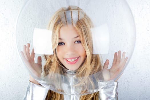 Astronaut futuristic kid girl with silver uniform and glass helmet